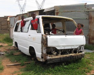 In these next photos, children are driving cars. Either they are playing on cars that were bought or found, or they use their imagination. These children are very creative. - Anele Bokuva