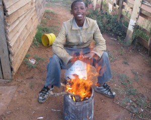 This boy is cooking his food outside because he does not have electricity or gas. - Mfundo Klaas
