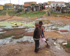 These children are playing in polluted water. This is bad because they can get a disease. -Abongile Hole
